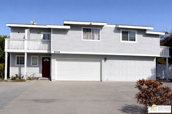 a front view of a house with a garage