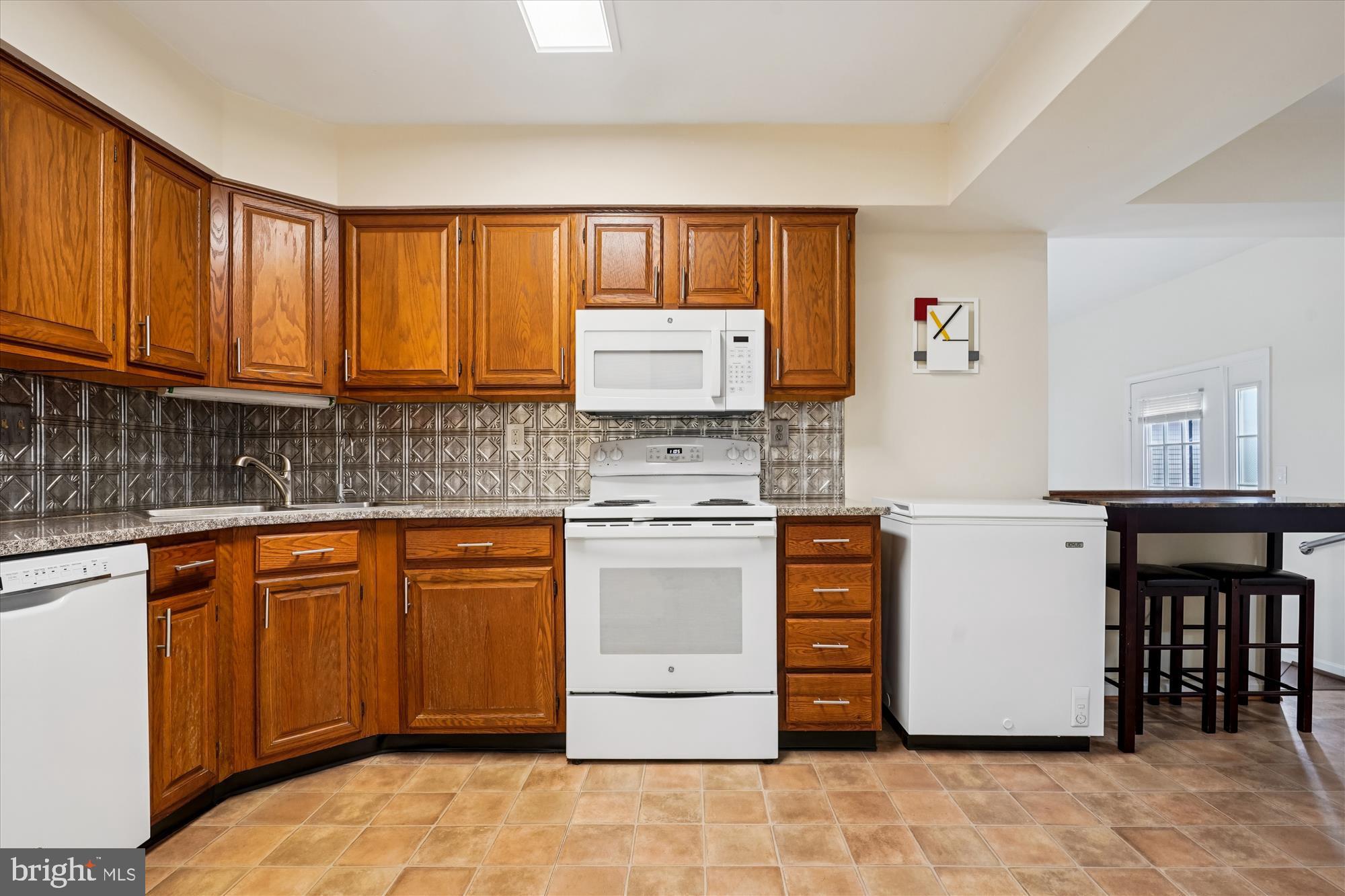 14511 Colonels Choice Road Upper Marlboro, MD 20772 - Photo 11 of 41 a kitchen with stainless steel appliances granite countertop a stove a sink and a refrigerator