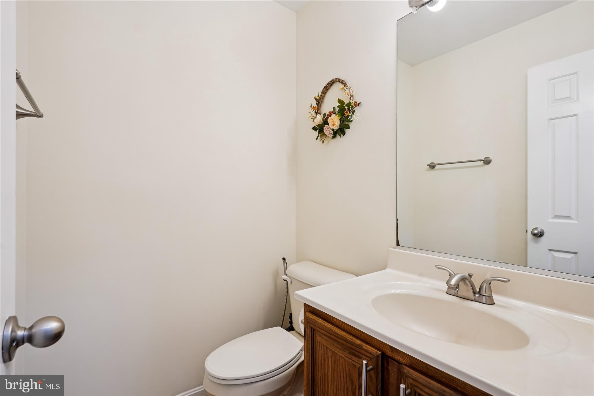 14511 Colonels Choice Road Upper Marlboro, MD 20772 - Photo 17 of 41 a bathroom with a sink toilet and mirror