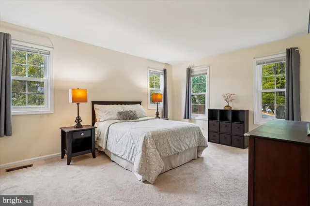 a bedroom with a bed lamps and window