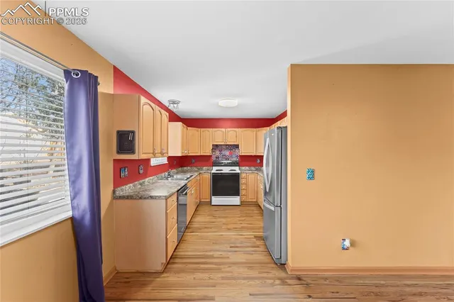a kitchen view with stainless steel appliances a stove and a refrigerator