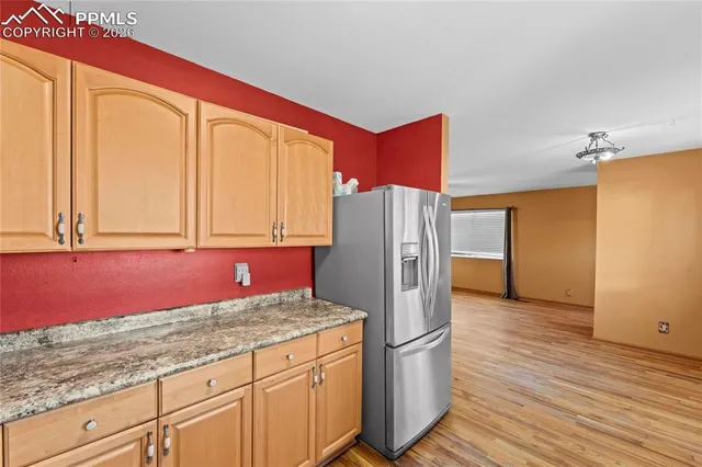 a kitchen with stainless steel appliances granite countertop a refrigerator and a sink