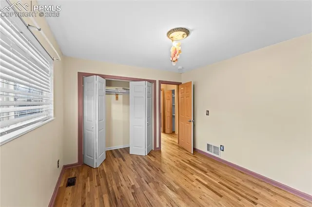 a view of a room with wooden floor and bathroom