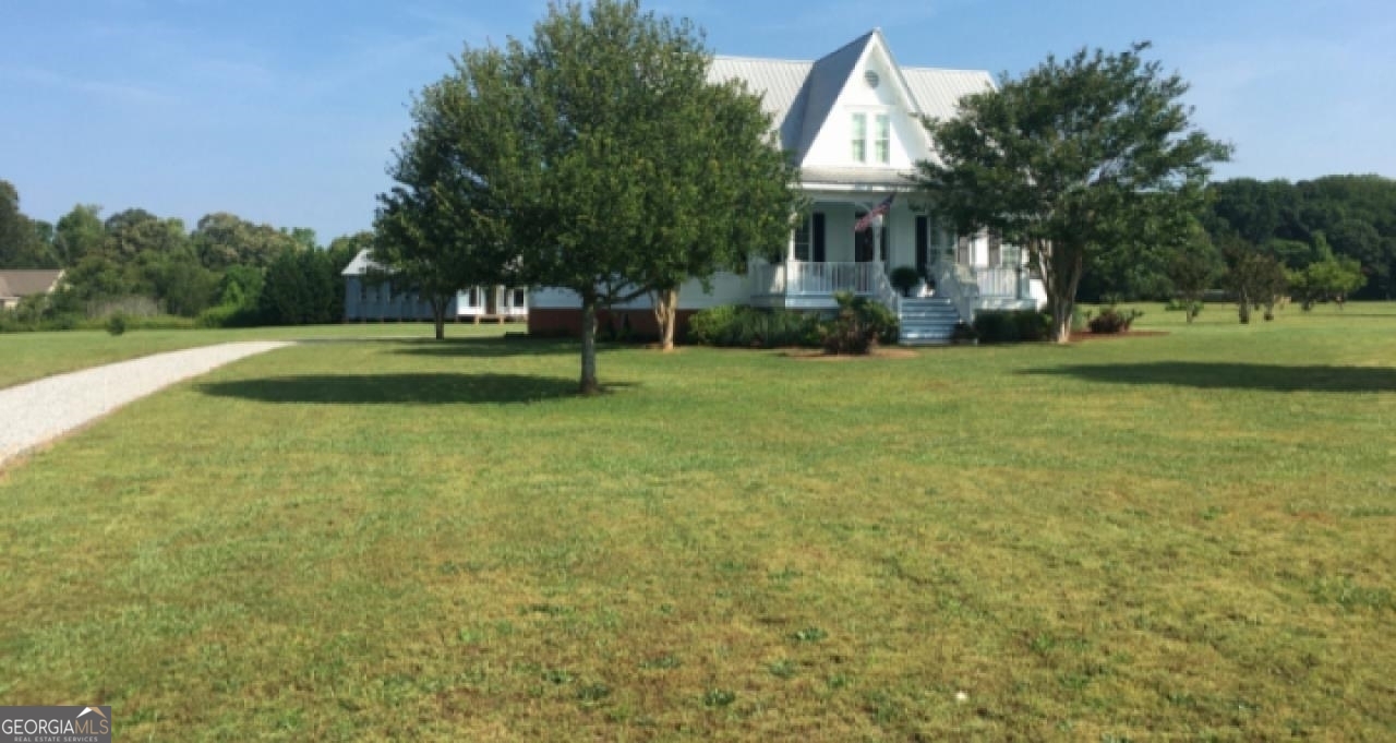 1200 Carson-Graves Road Watkinsville, GA 30677 - Photo 1 of 1 a front view of a house with a yard and trees