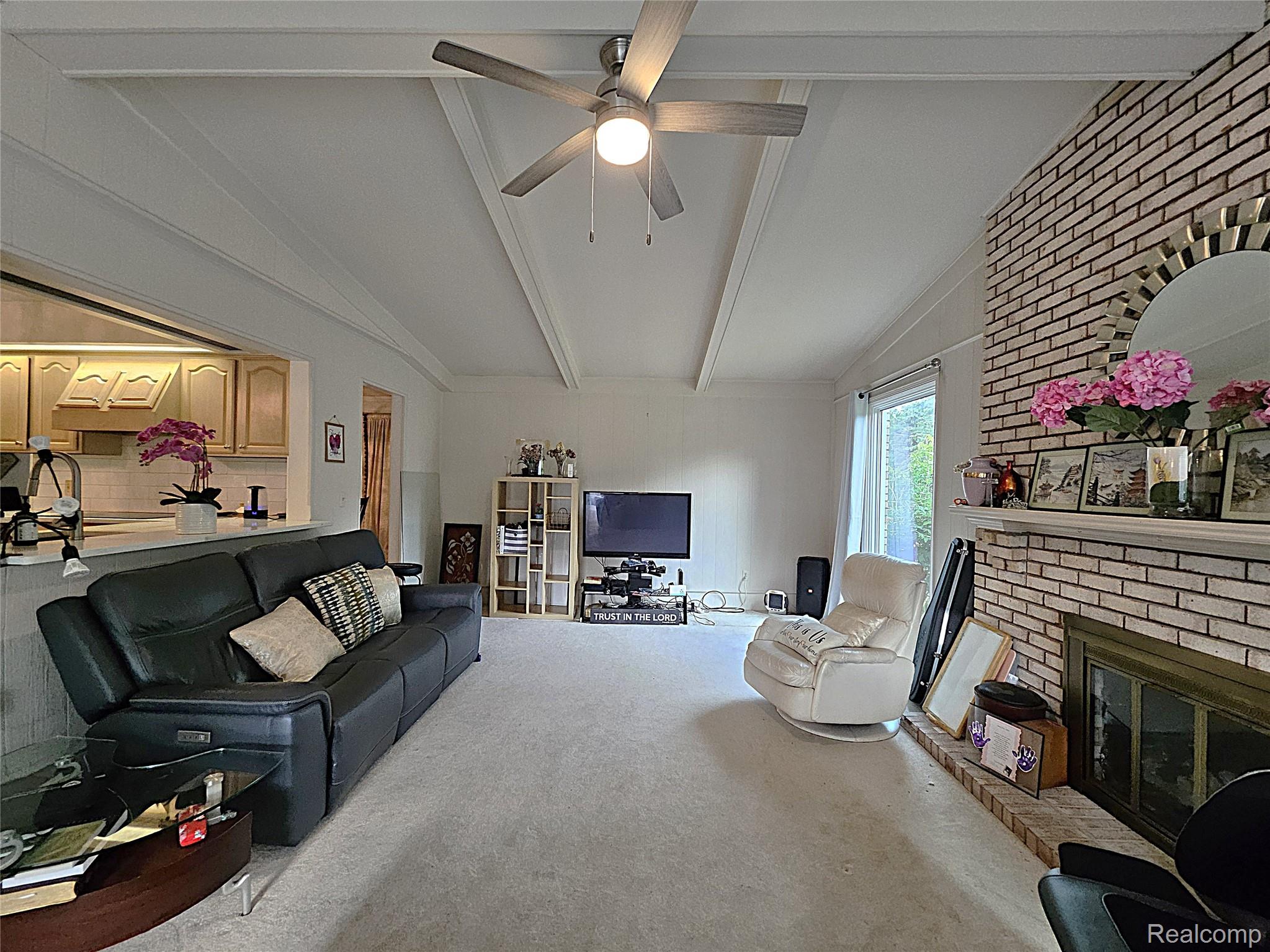 1114 Chaffer Drive Rochester, MI 48306 - Photo 19 of 50 Living room featuring a vaulted ceiling with exposed beams and a ceiling fan