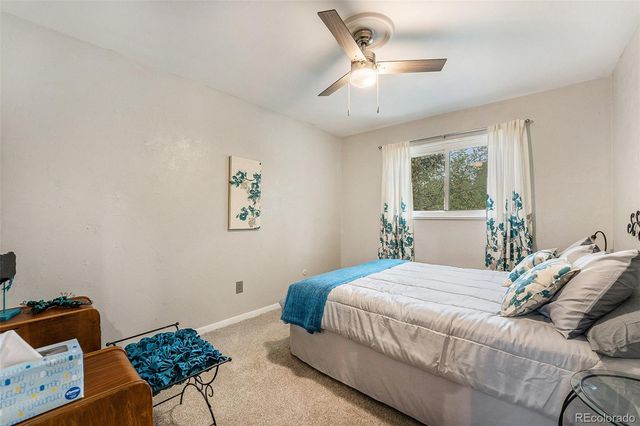 a bedroom with a bed window and couch