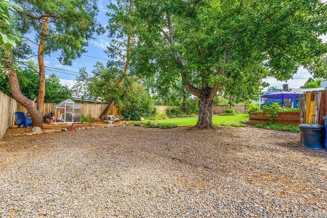a view of a house with a yard and tree s