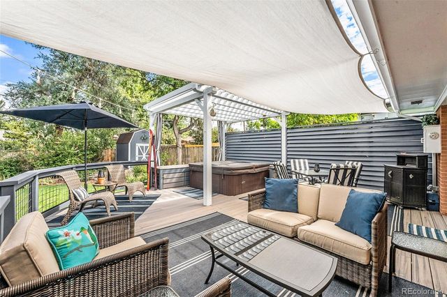 a balcony with furniture and a potted plant
