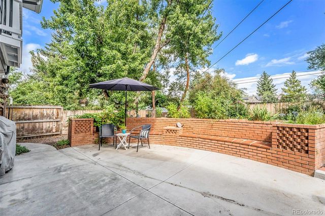 a view of backyard with outdoor seating and trees