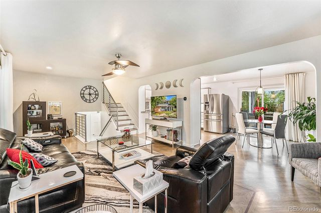 a living room with furniture and a chandelier