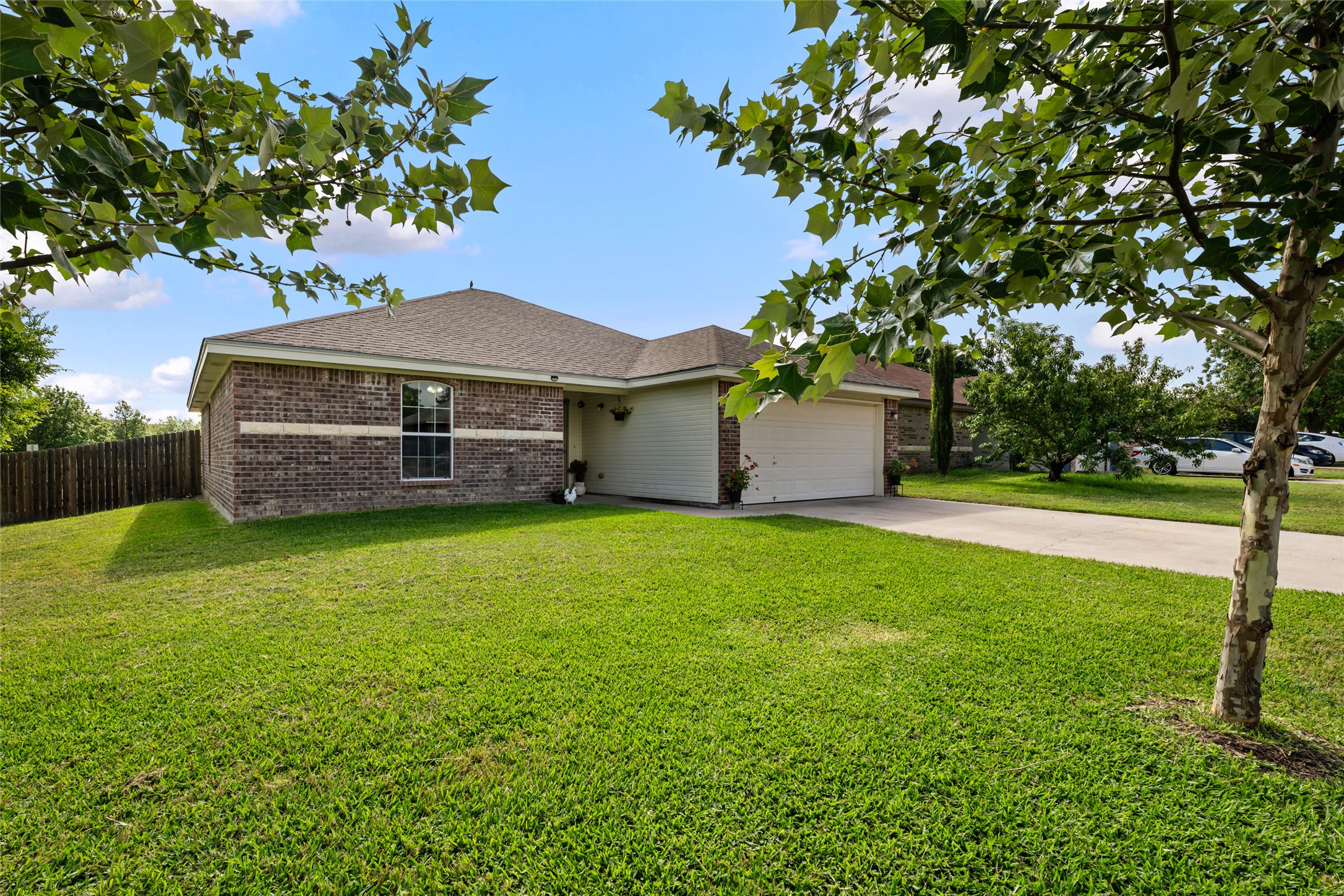 144 Calcite Lane Jarrell, TX 76537 - Photo 4 of 38 A well-kept front yard and brick exterior create a welcoming approach to this comfortable residence.