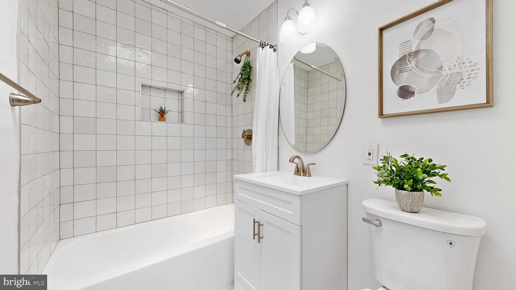 48 Girard Street Northeast Washington, DC 20002 - Photo 12 of 43 a bathroom with a sink a bathtub and a shower