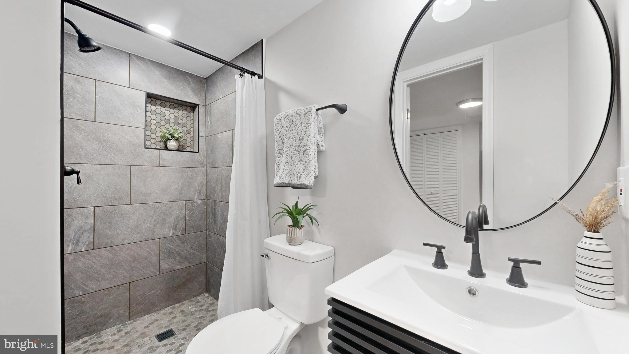 48 Girard Street Northeast Washington, DC 20002 - Photo 14 of 43 a bathroom with a sink toilet and a mirror