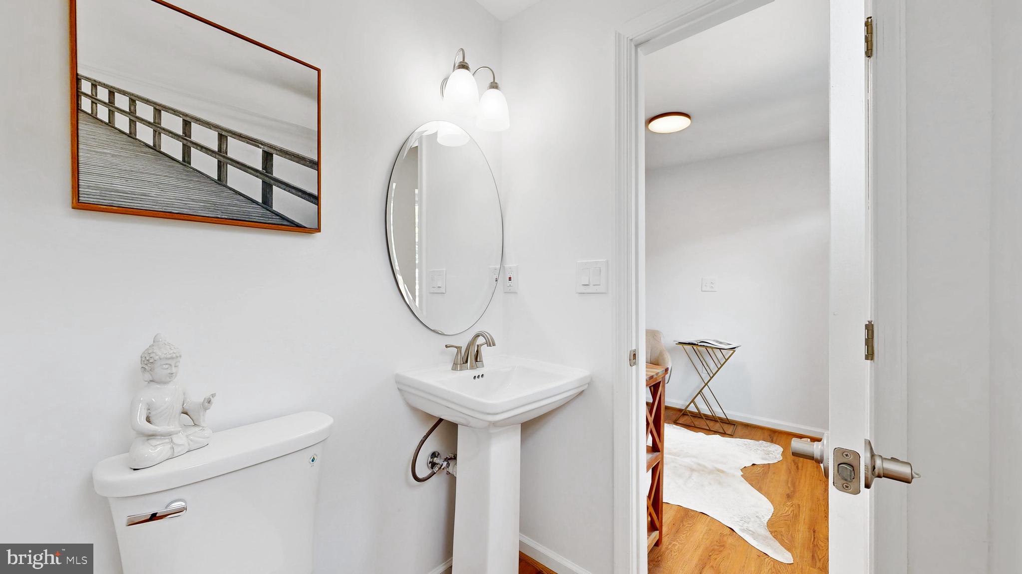 48 Girard Street Northeast Washington, DC 20002 - Photo 18 of 43 a bathroom with a sink mirror and vanity