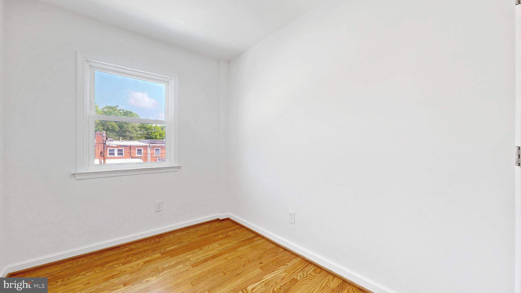 48 Girard Street Northeast Washington, DC 20002 - Photo 20 of 43 a view of a big room with wooden floor and a window