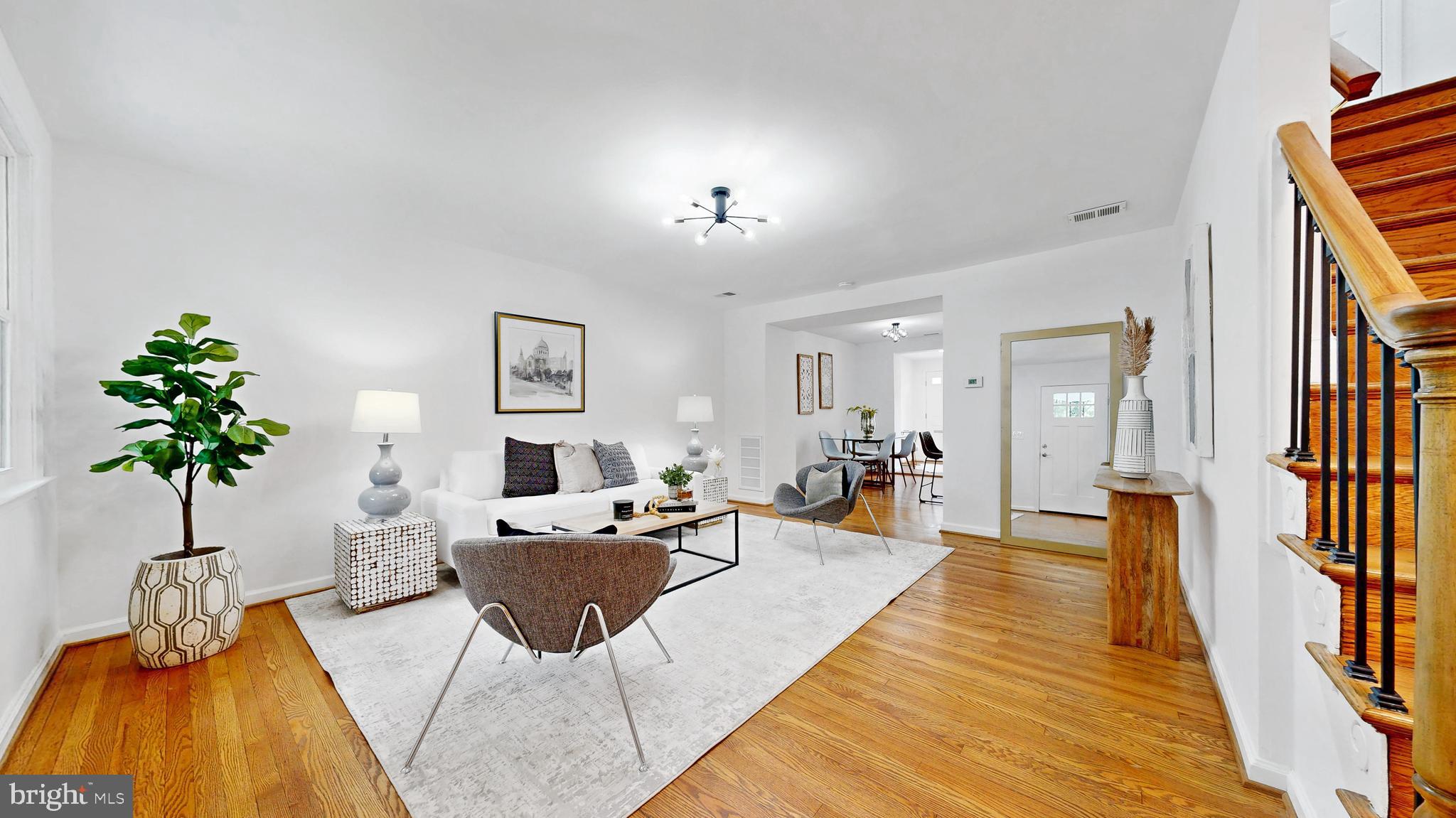 48 Girard Street Northeast Washington, DC 20002 - Photo 2 of 43 a living room with furniture and a potted plant