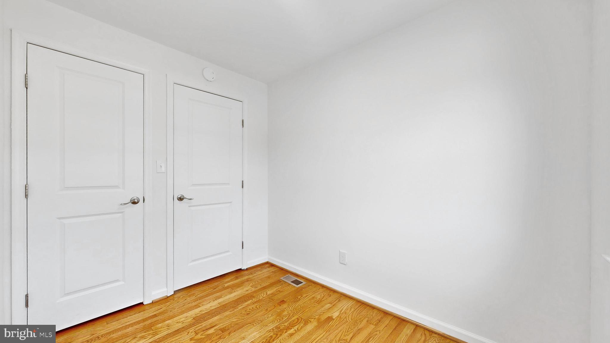48 Girard Street Northeast Washington, DC 20002 - Photo 22 of 43 a view of empty room with wooden floor