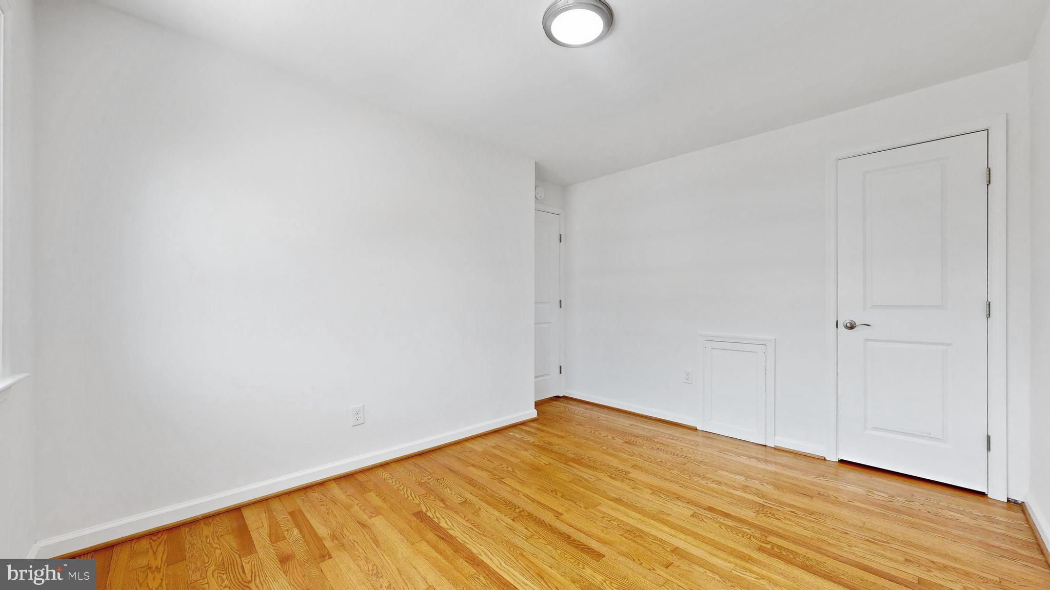 48 Girard Street Northeast Washington, DC 20002 - Photo 23 of 43 a view of empty room with wooden floor
