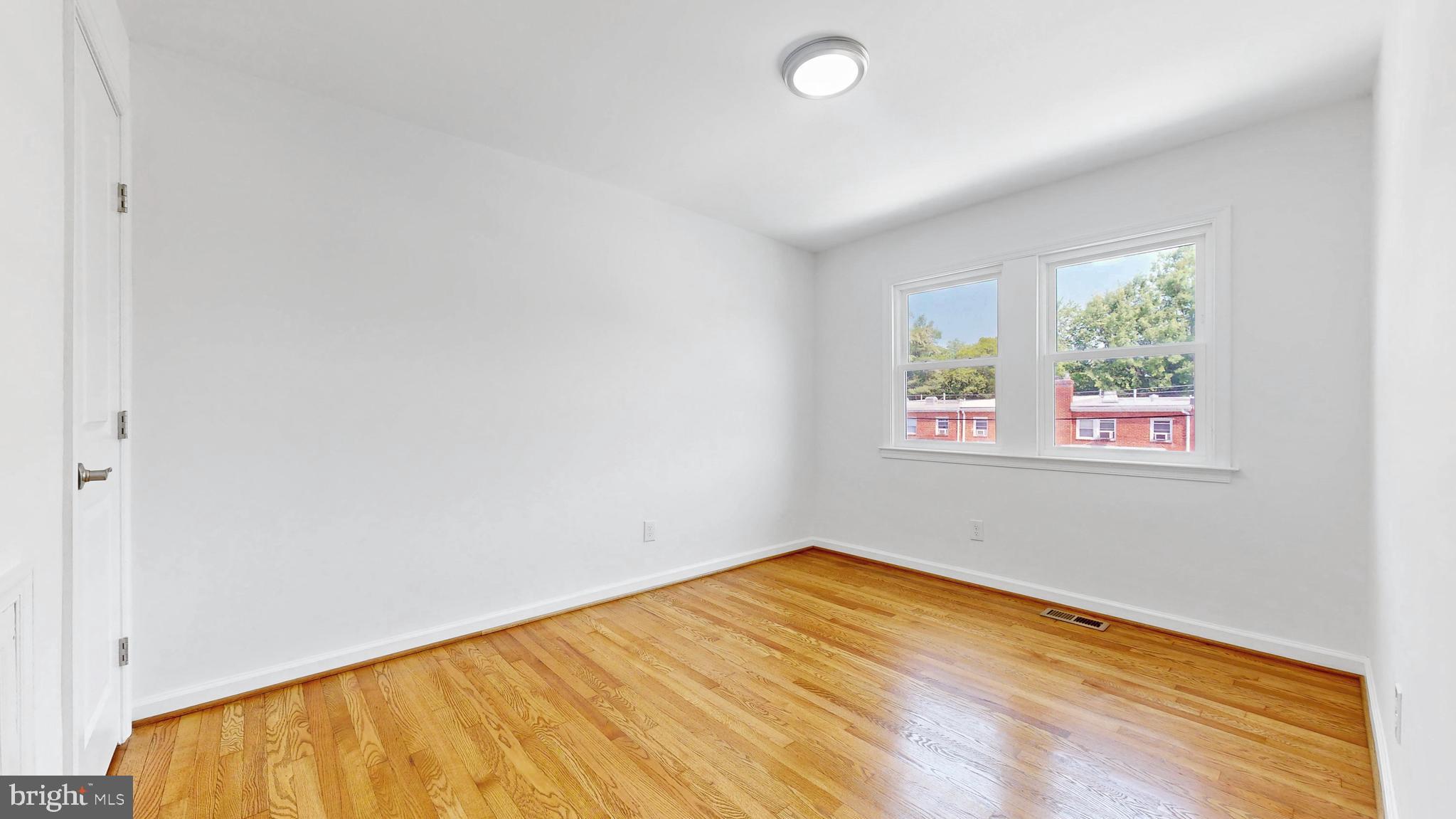 48 Girard Street Northeast Washington, DC 20002 - Photo 25 of 43 a view of empty room with wooden floor