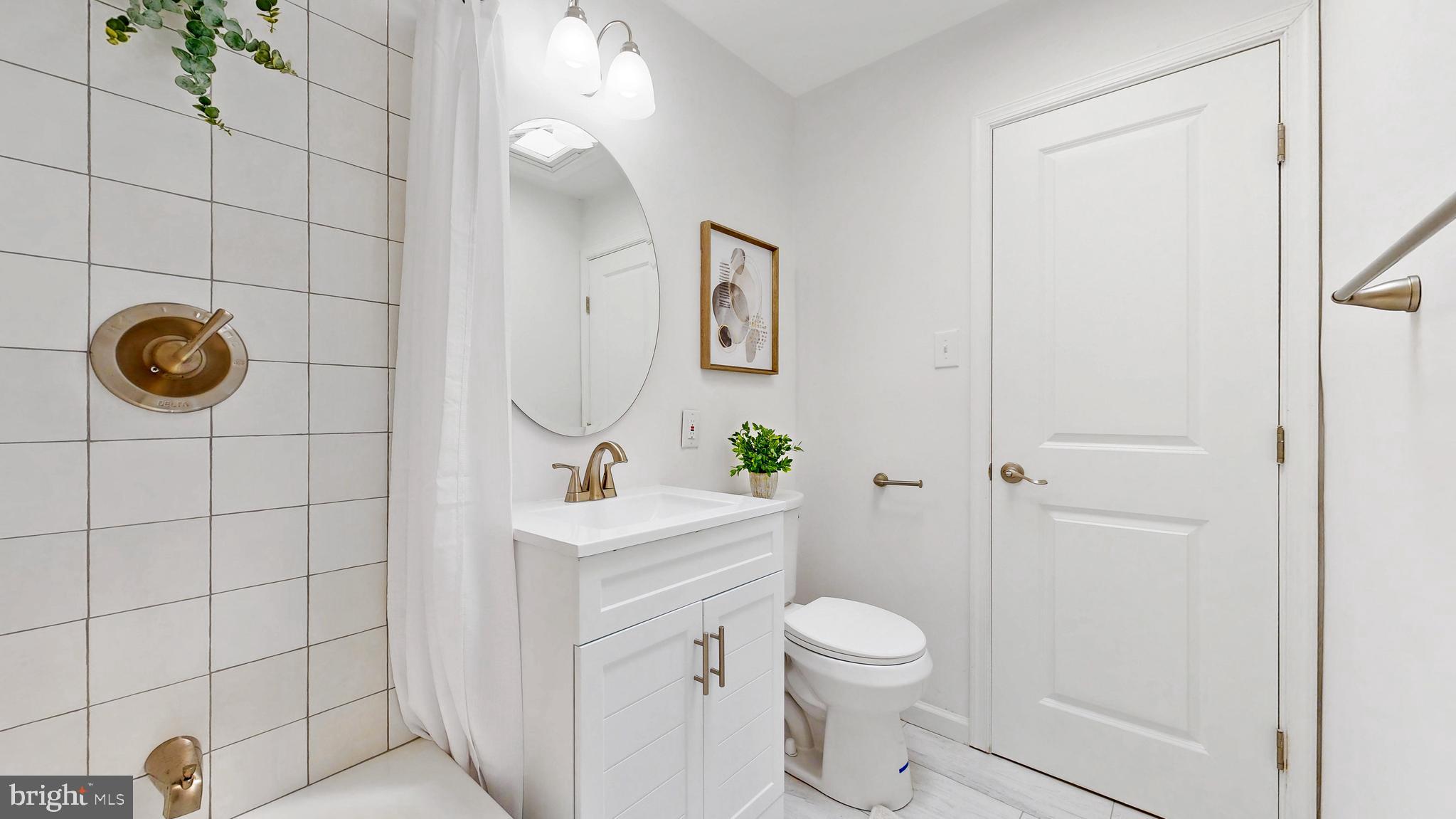 48 Girard Street Northeast Washington, DC 20002 - Photo 26 of 43 a bathroom with a toilet a sink and shower