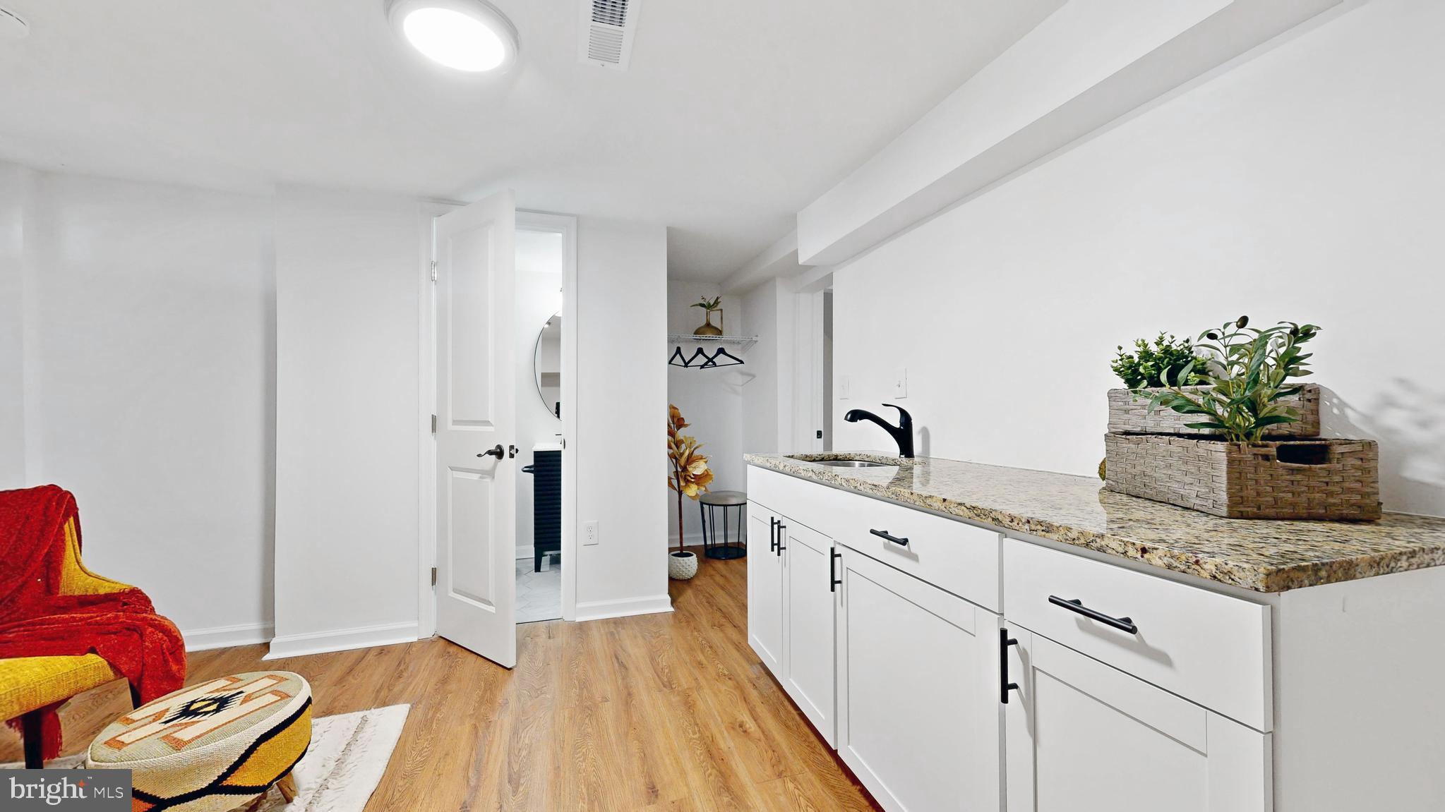48 Girard Street Northeast Washington, DC 20002 - Photo 30 of 43 a spacious bathroom with a granite countertop sink and a mirror