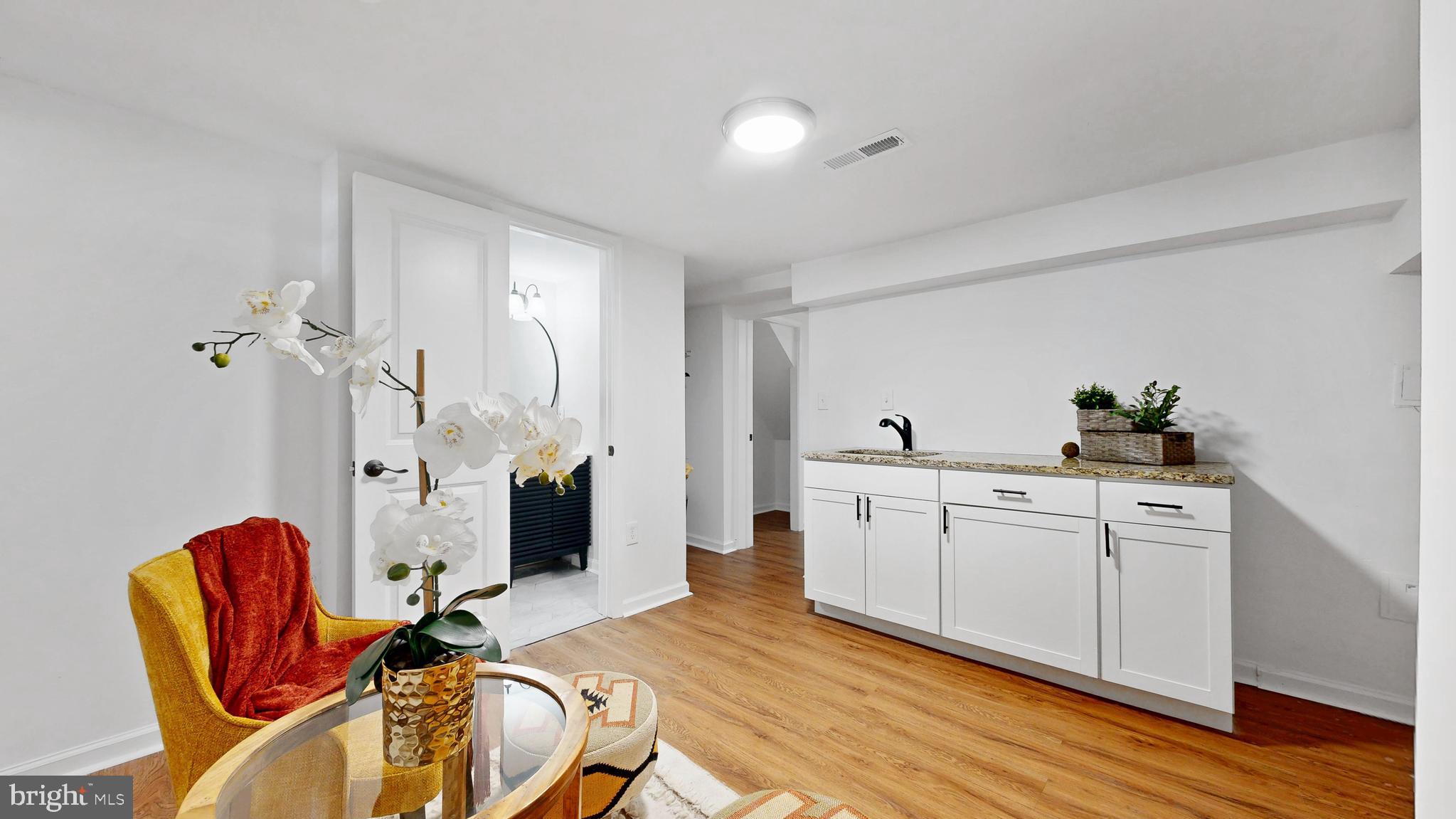 48 Girard Street Northeast Washington, DC 20002 - Photo 31 of 43 a bed room with furniture and wooden floor