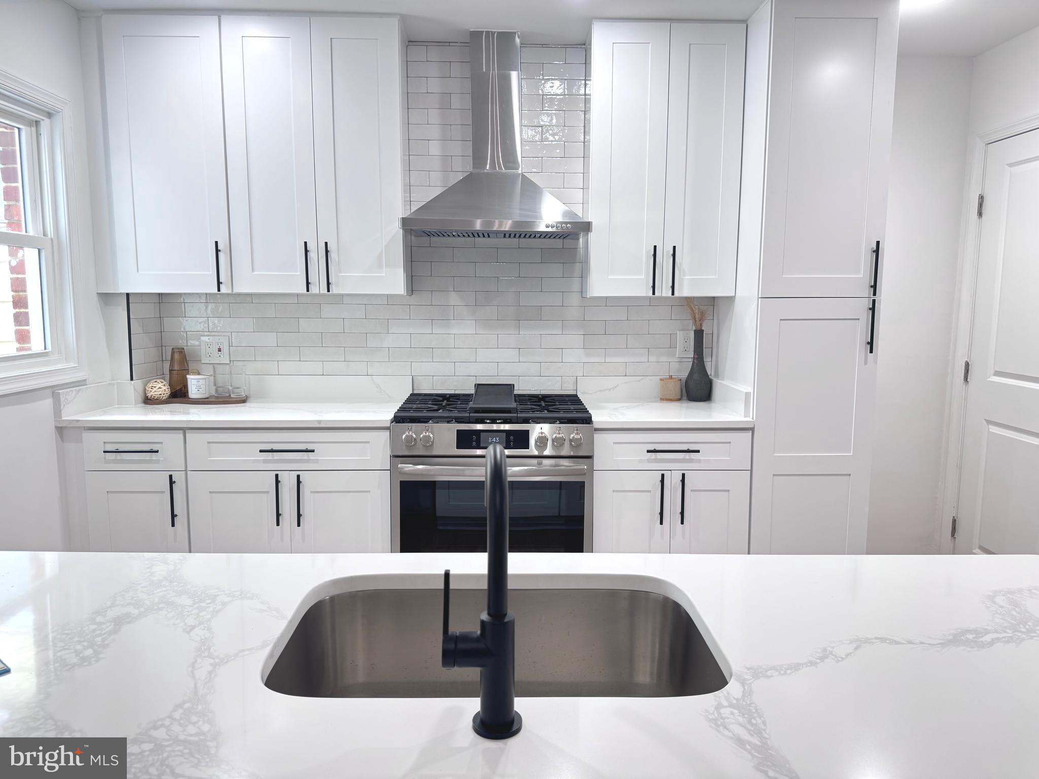 48 Girard Street Northeast Washington, DC 20002 - Photo 4 of 43 a kitchen with stainless steel appliances granite countertop a sink stove and refrigerator