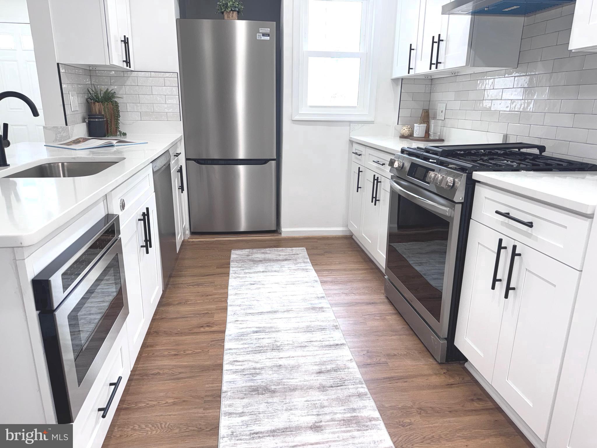 48 Girard Street Northeast Washington, DC 20002 - Photo 5 of 43 a kitchen with a sink a refrigerator and a stove