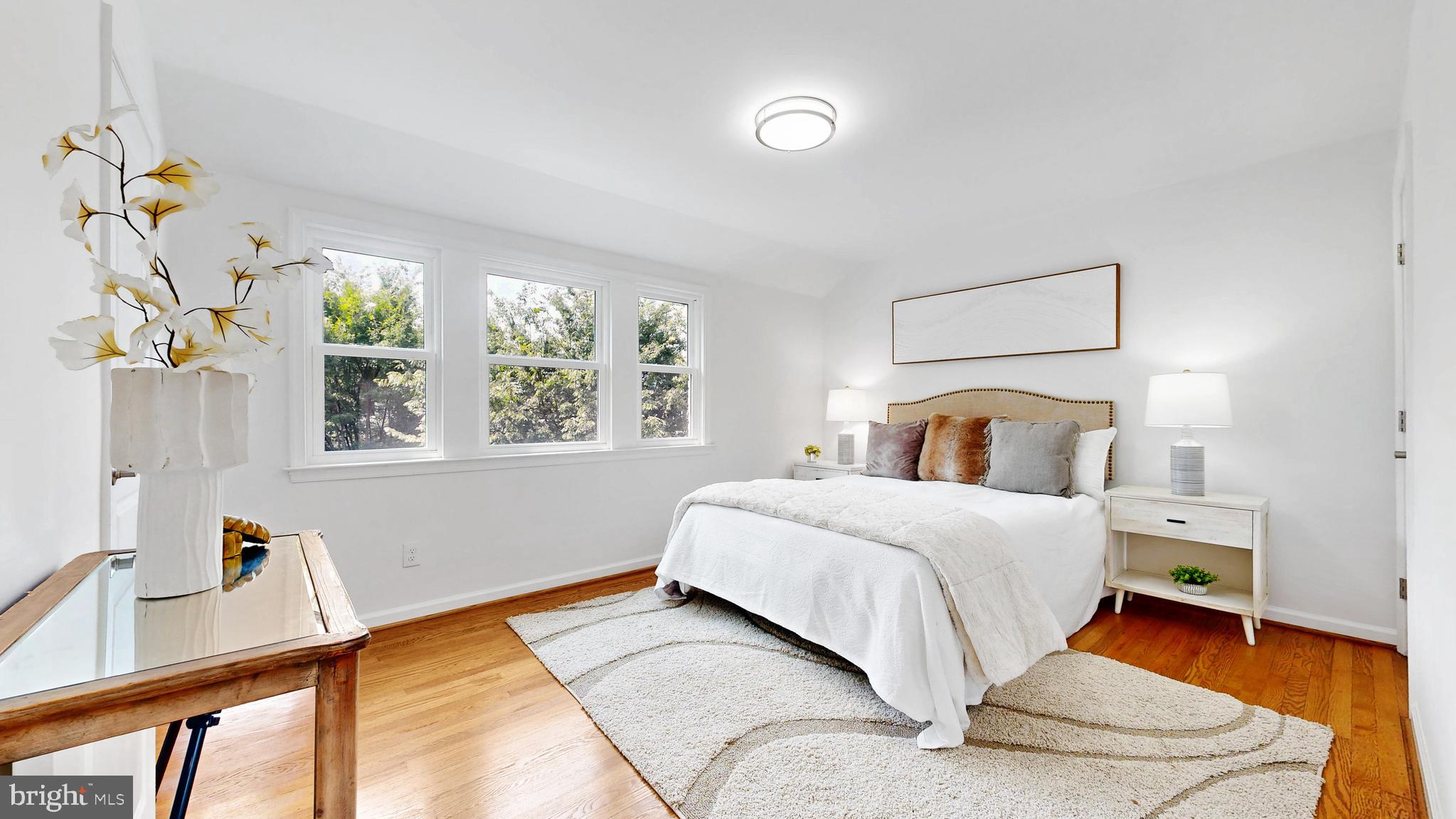 48 Girard Street Northeast Washington, DC 20002 - Photo 6 of 43 a bedroom with a bed and wooden floor