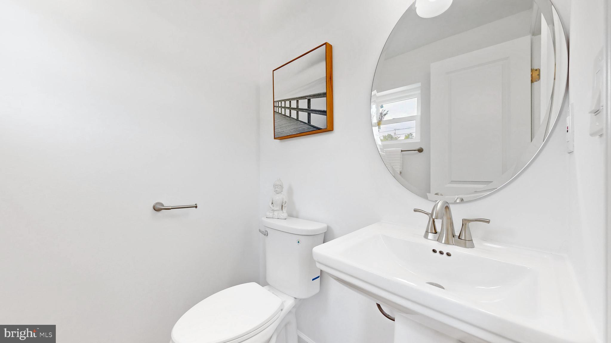 48 Girard Street Northeast Washington, DC 20002 - Photo 7 of 43 a bathroom with a sink mirror and toilet