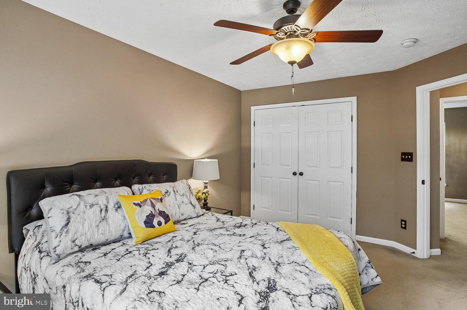 217 Raccoon Run Court Hanover, MD 21076 - Photo 22 of 38 a bedroom with a bed and a chandelier