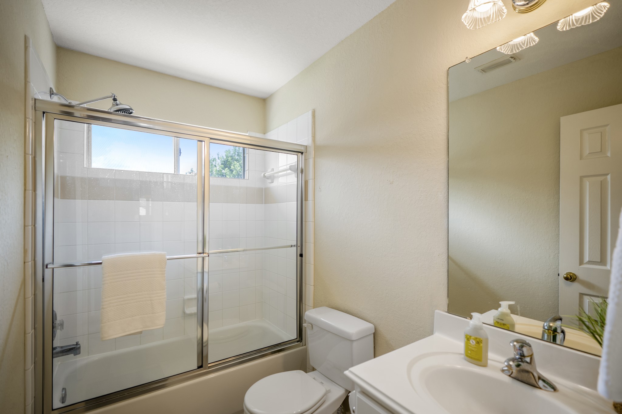 5807 Sequoia Trace Court Spring, TX 77379 - Photo 24 of 50 Conveniently located next to the upstairs study, this full bath features a tub/shower combination with a sliding glass enclosure, a window for natural light, and a single-sink vanity.