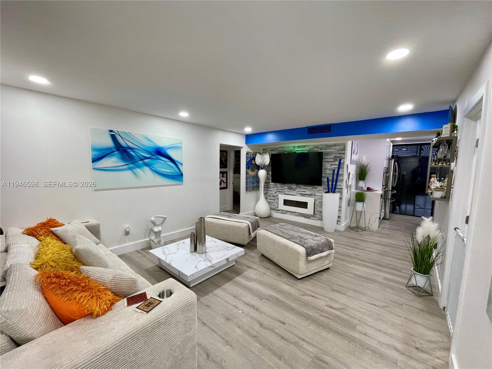 a living room with furniture and a flat screen tv