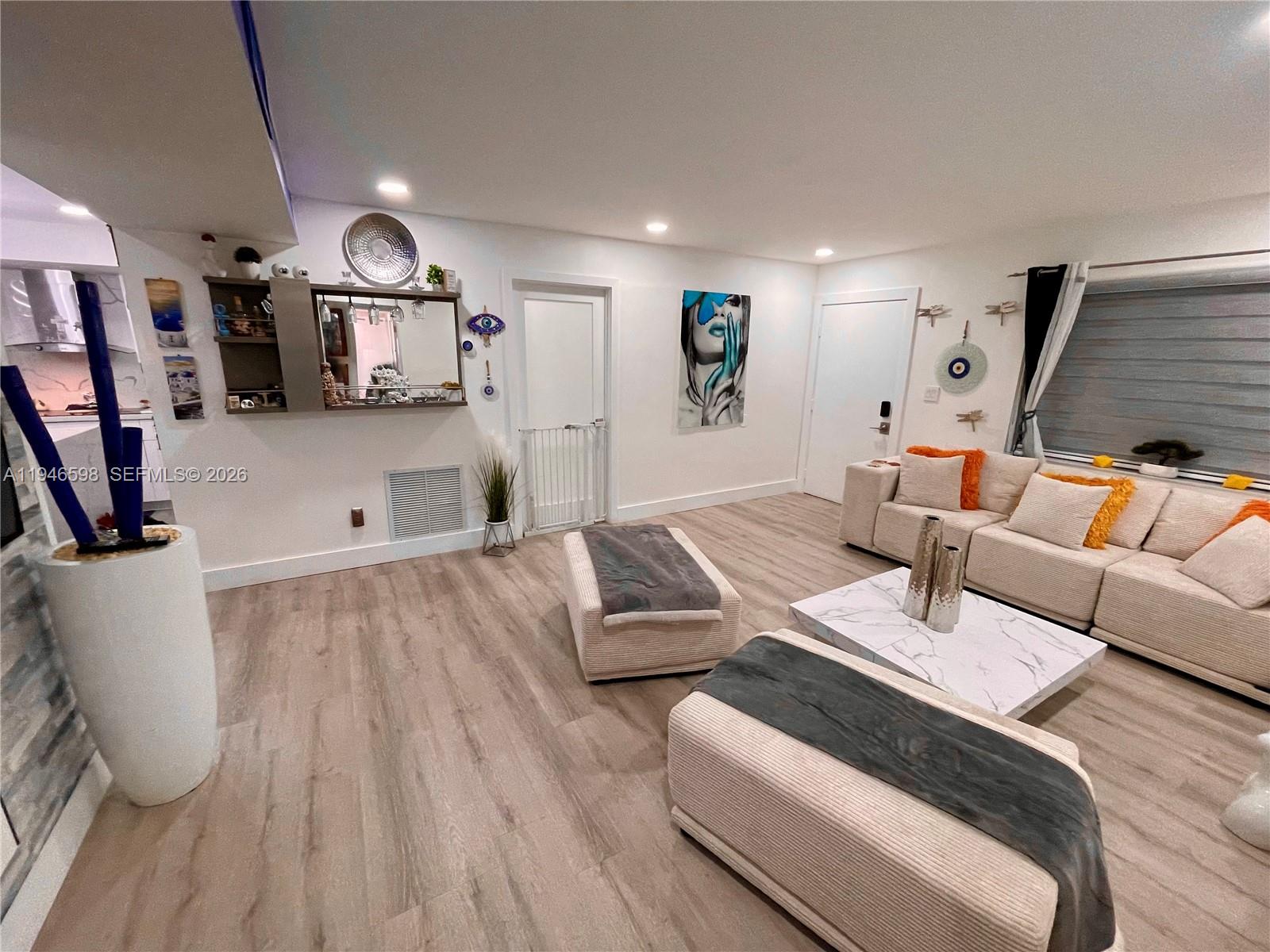 8635 Northwest 8th Street, Unit 311 Miami, FL 33126 - Photo 2 of 16 a living room with furniture and a flat screen tv