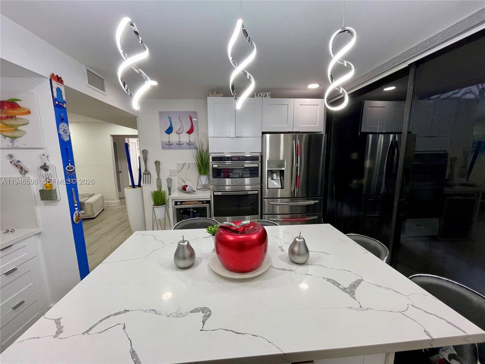 8635 Northwest 8th Street, Unit 311 Miami, FL 33126 - Photo 6 of 16 a view of a dining room with furniture