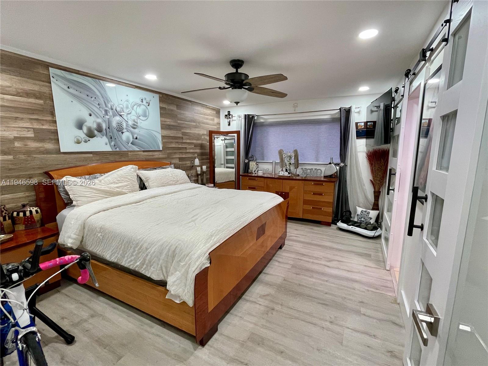 8635 Northwest 8th Street, Unit 311 Miami, FL 33126 - Photo 8 of 16 a bed room with a bed and a walk in closet