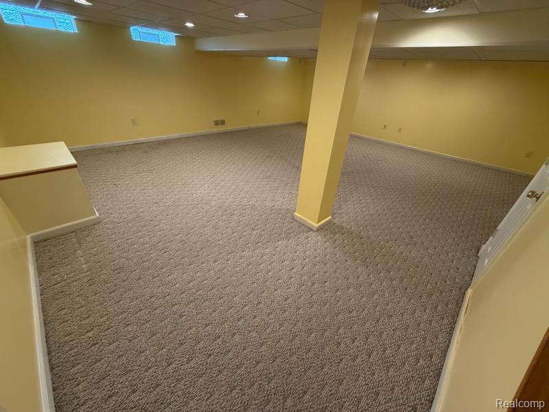 28144 Yorktown Road Farmington, MI 48331 - Photo 20 of 25 Expansive finished lower level featuring patterned carpeting, recessed lighting, drop ceiling, and multiple glass block windows