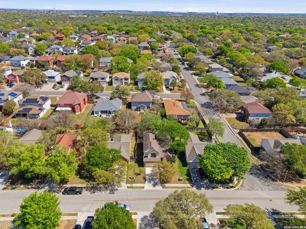 an aerial view of residential houses with outdoor space