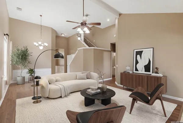 a living room with furniture and a chandelier