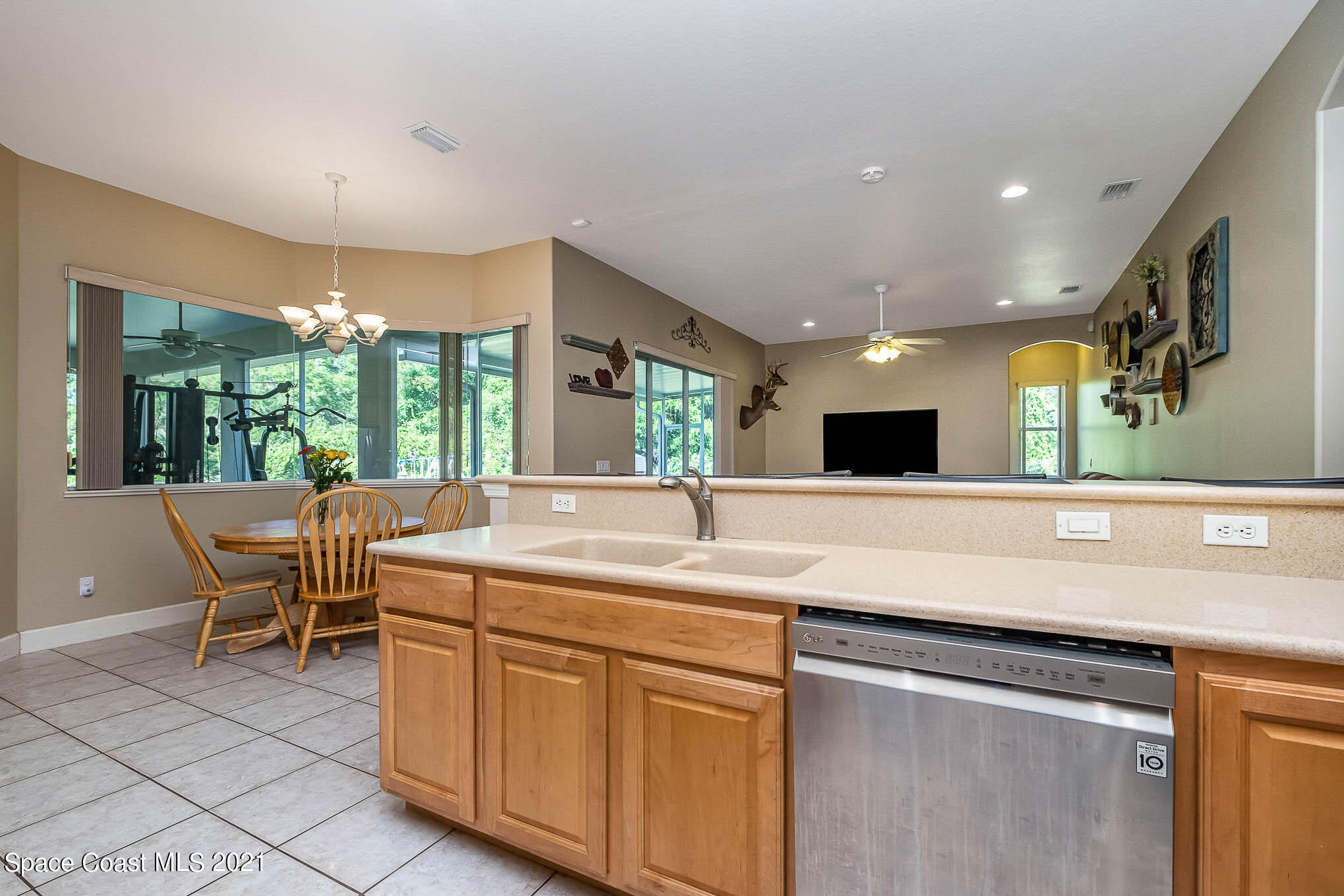 4329 Hunter Road Mims, FL 32754 - Photo 12 of 35 a kitchen with a sink and chairs