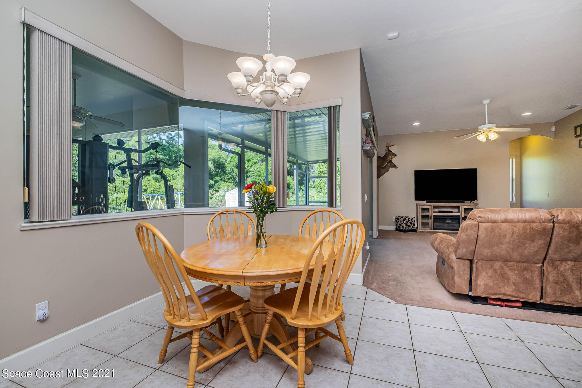4329 Hunter Road Mims, FL 32754 - Photo 14 of 35 a view of a dining room with furniture a chandelier and window