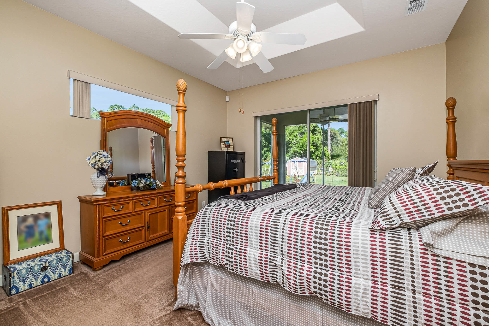 4329 Hunter Road Mims, FL 32754 - Photo 20 of 35 a bedroom with a bed and a chandelier