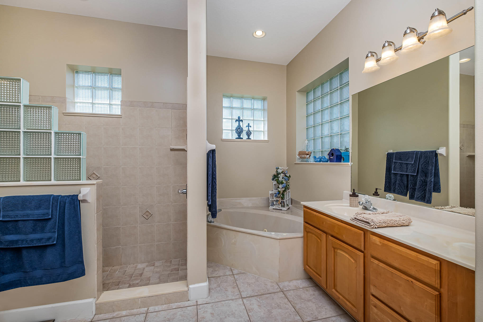 4329 Hunter Road Mims, FL 32754 - Photo 21 of 35 a bathroom with a tub sink and a mirror