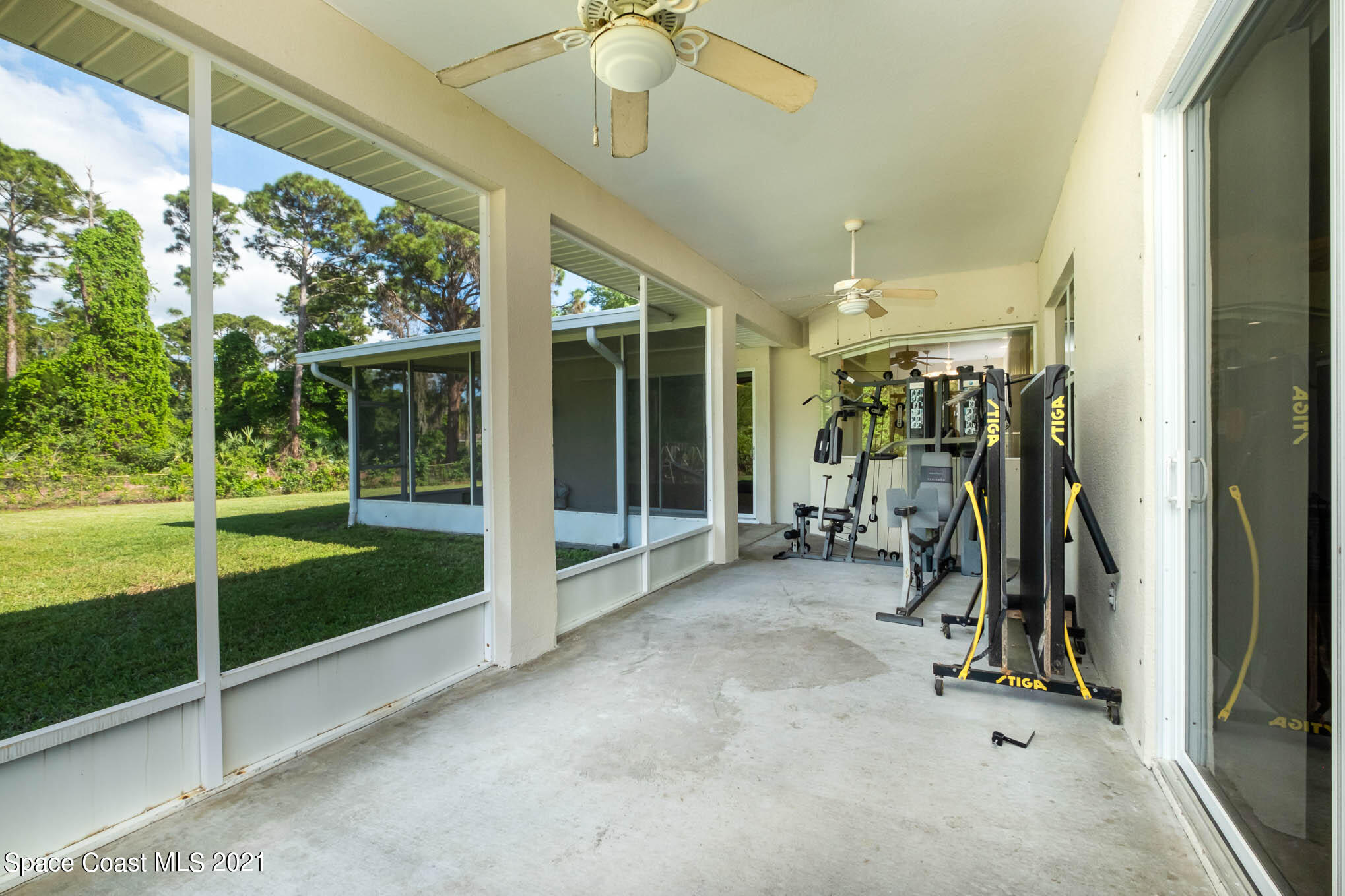 4329 Hunter Road Mims, FL 32754 - Photo 31 of 35 a room with gym equipment and large windows
