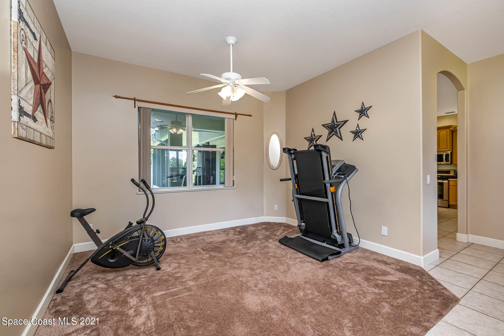 4329 Hunter Road Mims, FL 32754 - Photo 8 of 35 a room with gym equipment and a window