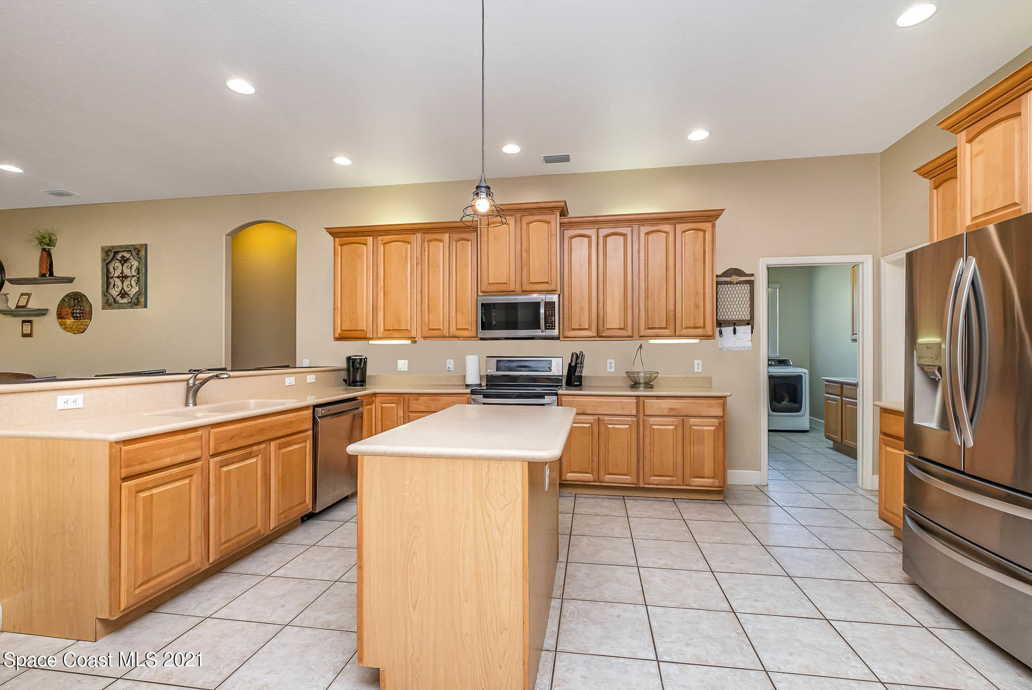 4329 Hunter Road Mims, FL 32754 - Photo 10 of 35 a kitchen with a sink a counter top space cabinets and stainless steel appliances