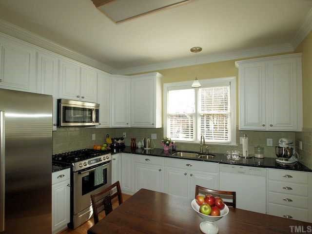 604 Leonidas Court Raleigh, NC 27604 - Photo 3 of 12 Many recent updates have been made to the kitchen...new granite counters, Italian tile backsplash, new dual fuel range, microwave, sink and faucet. The cabinets have all new doors and hardware. Kitchen