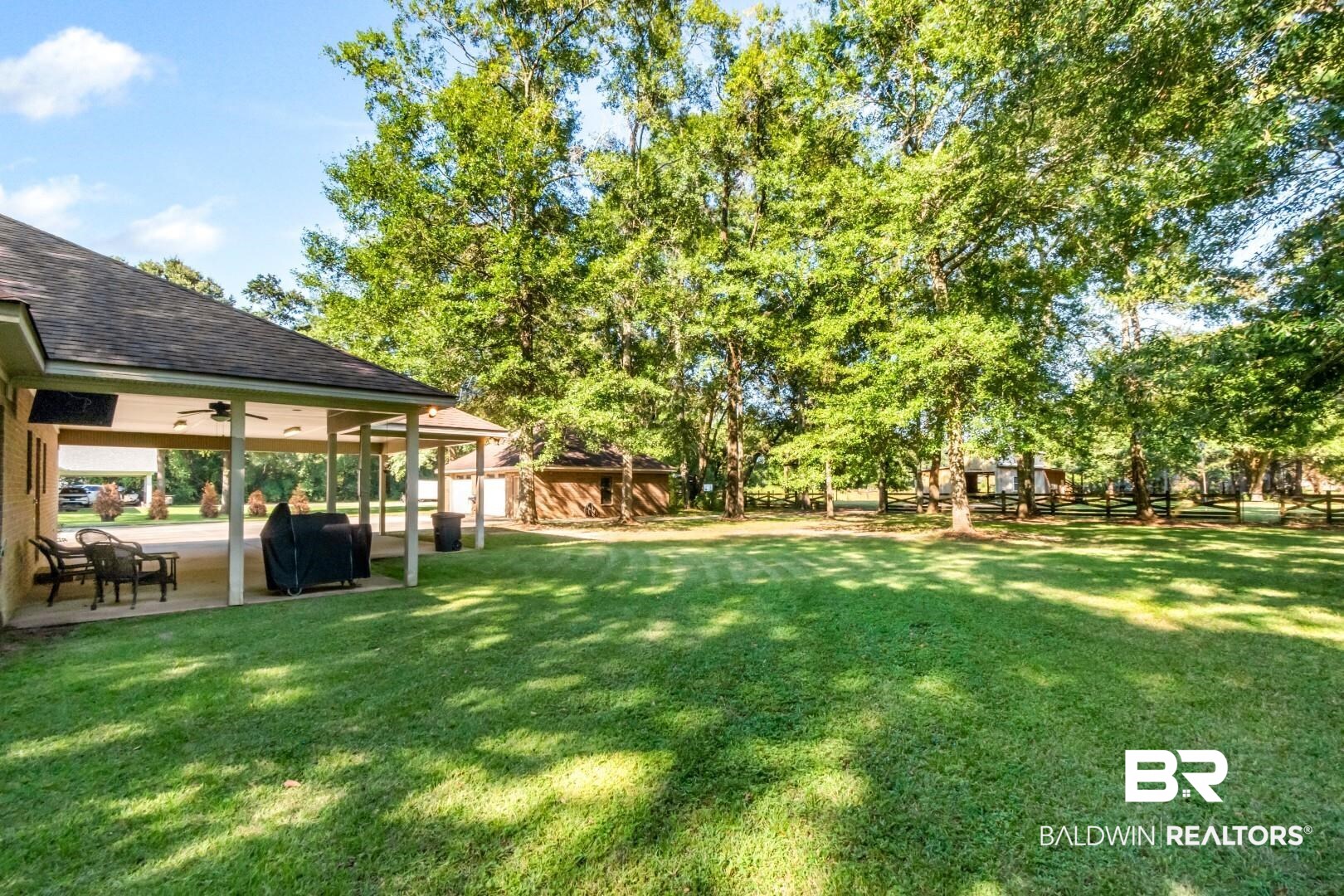 1360 Dykes Road North Mobile, AL 36608 - Photo 29 of 40 View of green lawn with a patio area and a ceiling fan