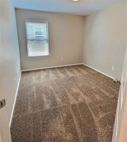 an empty room with a chandeliers