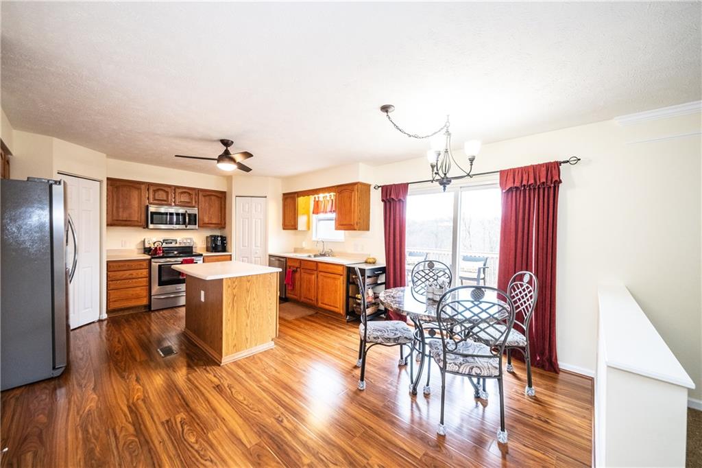 518 Blue Ridge Drive Coraopolis, PA 15108 - Photo 5 of 25 Eat-in kitchen, adjacent to family room leads out to upper deck over looking treed landscape.